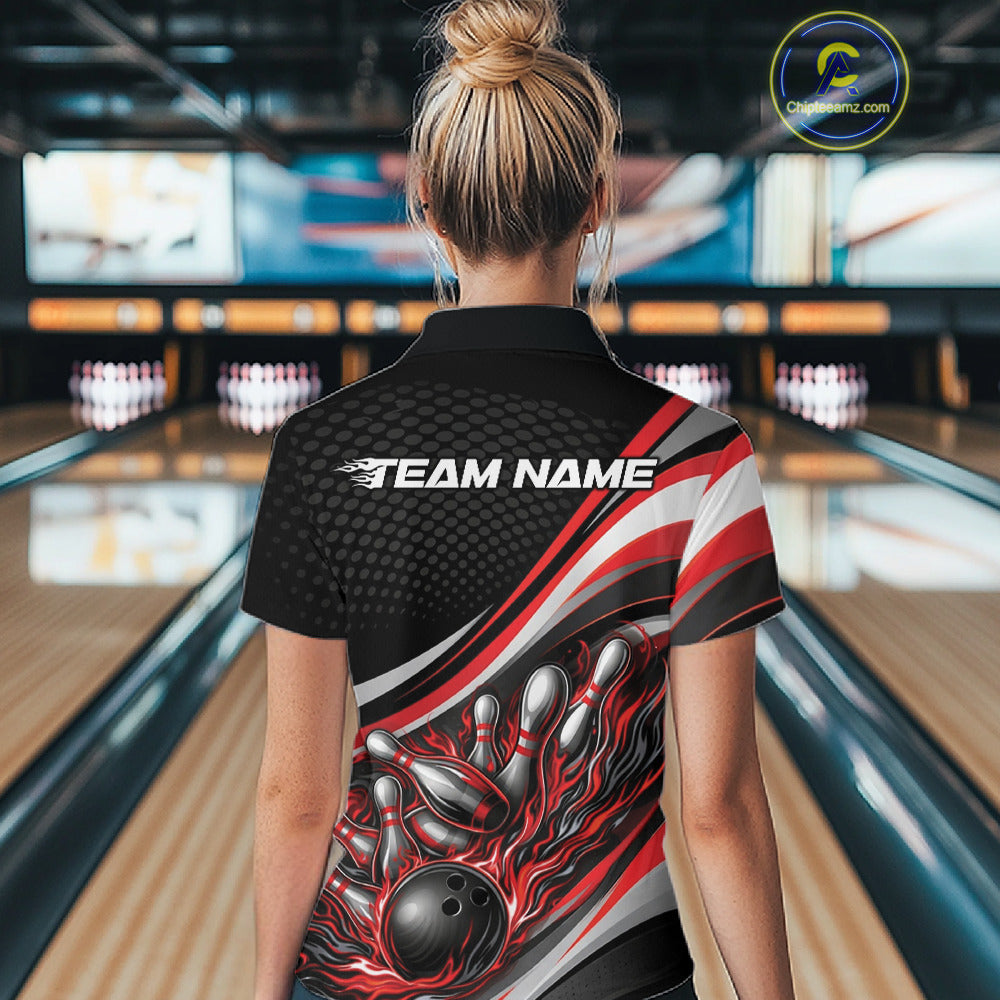 Back view of a female bowler wearing a black and red polo shirt, flame bowling strike design with dramatic pin impact scene.