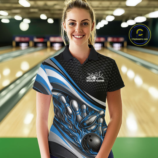 Female model in a bowling lane wearing a black and blue polo shirt, flaming bowling ball hitting pins with dynamic sports design.