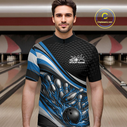 Male model at a bowling lane wearing a black and blue quarter-zip shirt, flaming bowling ball striking pins with dynamic motion design.