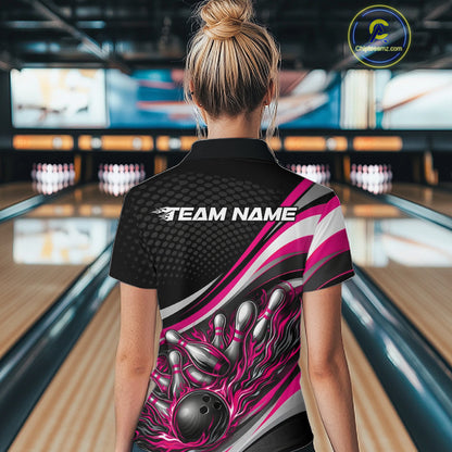 Back view of a female bowler wearing a black and pink polo shirt, flame bowling strike artwork with pins scattering effect.