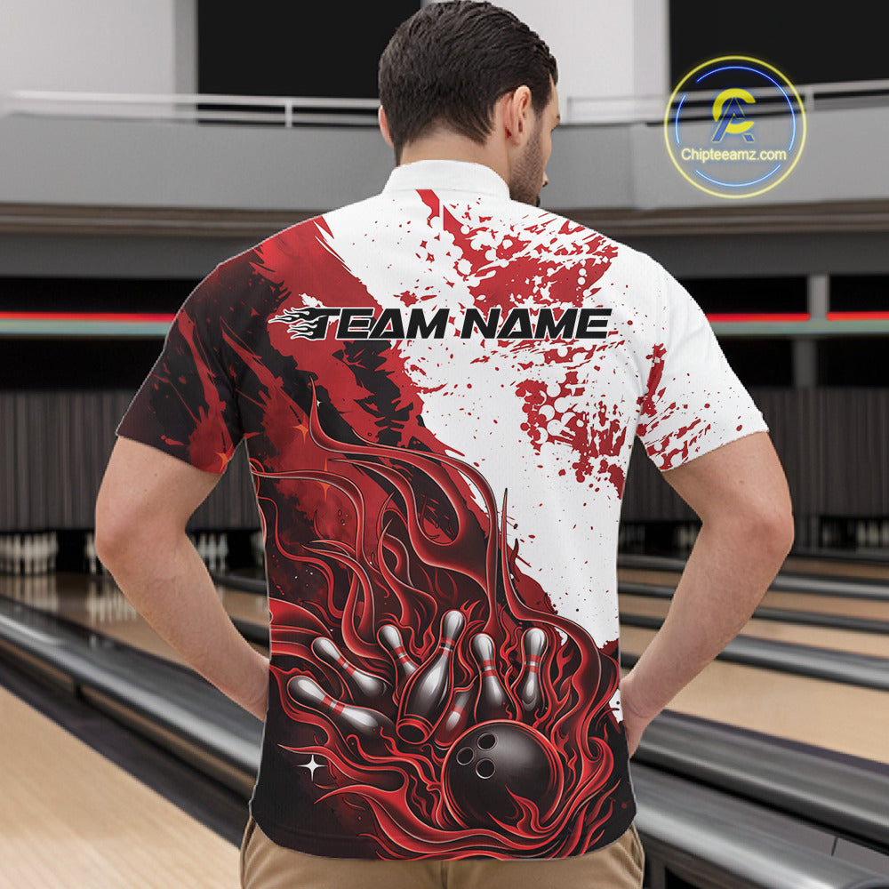 Front view of a male model in a bowling lane wearing a black quarter-zip shirt featuring red and white flame bowling ball and pins artwork with bold athletic bowling styling.