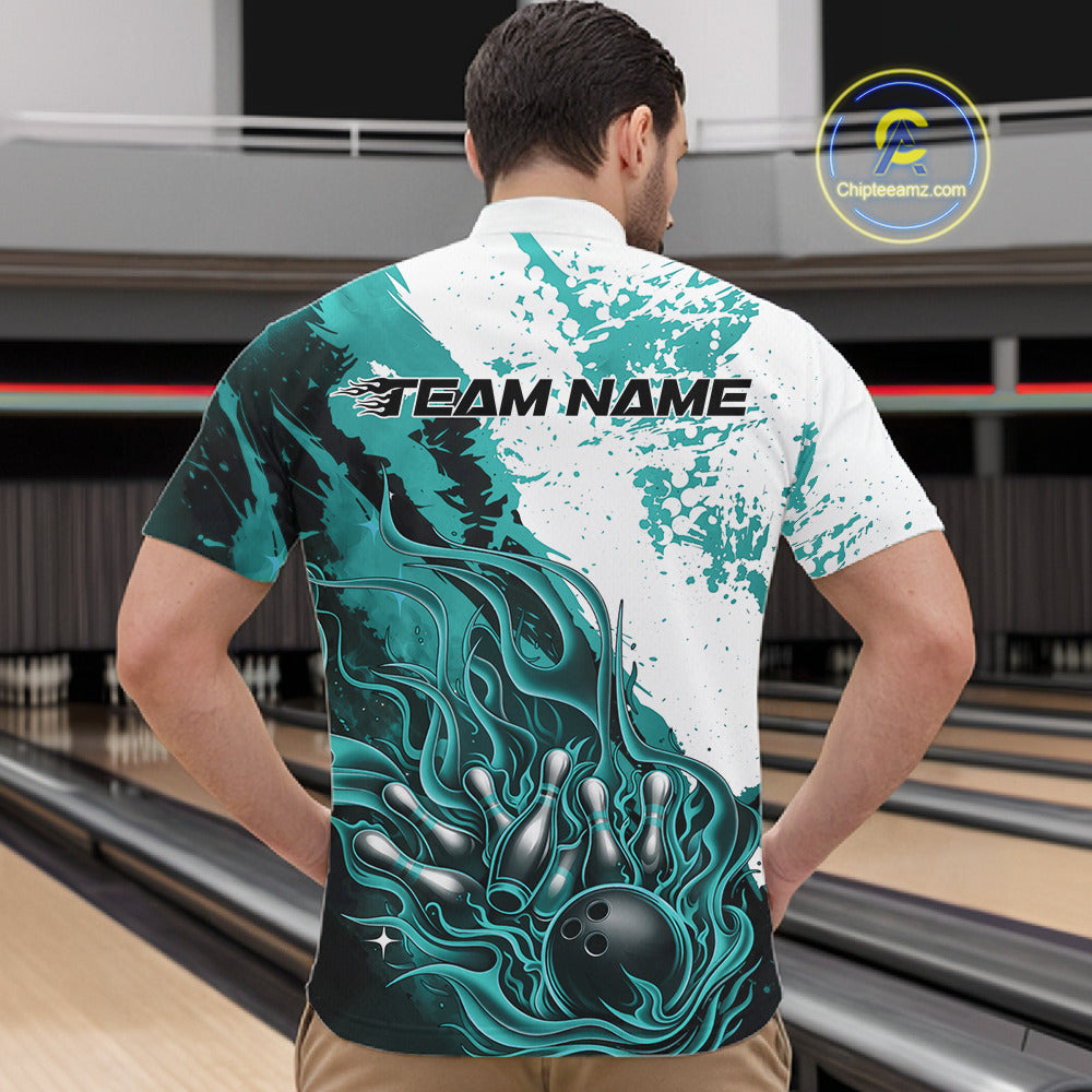Front view of a male model in a bowling lane wearing a black quarter-zip shirt featuring turquoise blue and white flame bowling ball and pins design with clean sporty visuals.