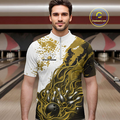 Front view of a male model in a bowling lane wearing a black quarter-zip shirt with black, yellow and white flame bowling ball and pins artwork and energetic bowling visuals.