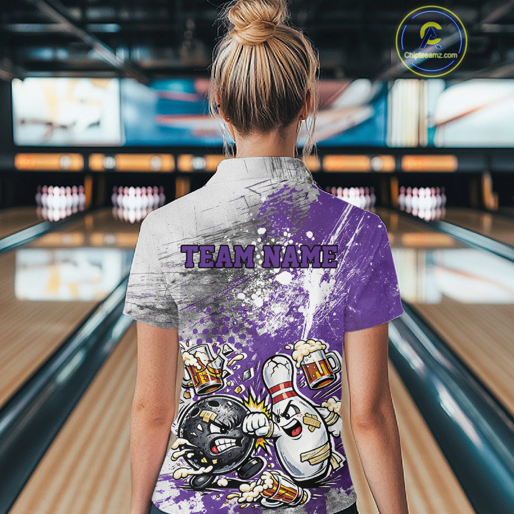 Back view of a female model in a bowling lane wearing a purple and white grunge splatter bowling quarter-zip shirt with a funny cartoon bowling ball and pin fist-fighting illustration.