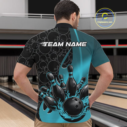 Male model in bowling alley front view wearing black and blue quarter zip shirt featuring flaming bowling ball striking pins with dynamic gradient design