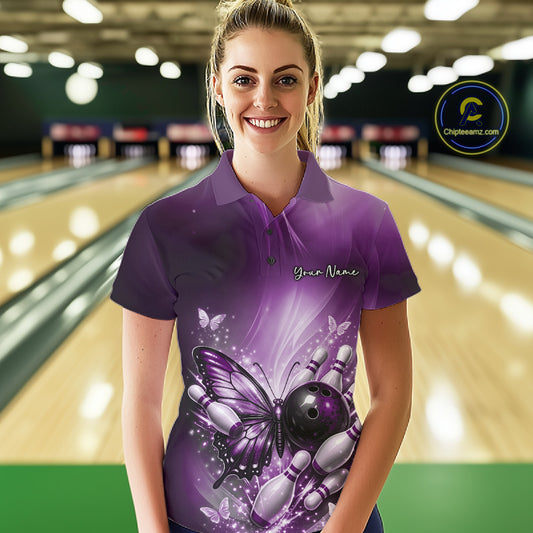 Female model wearing a purple bowling polo shirt at a bowling lane with butterfly artwork, a bowling ball, and scattered pin graphics.