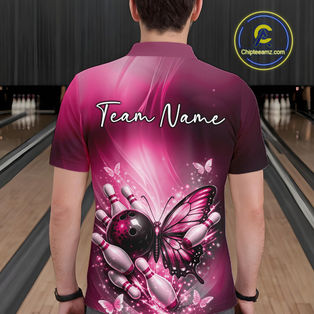 Back view of a male model in a bowling center wearing a pink polo shirt featuring a butterfly beside a bowling ball and pins.