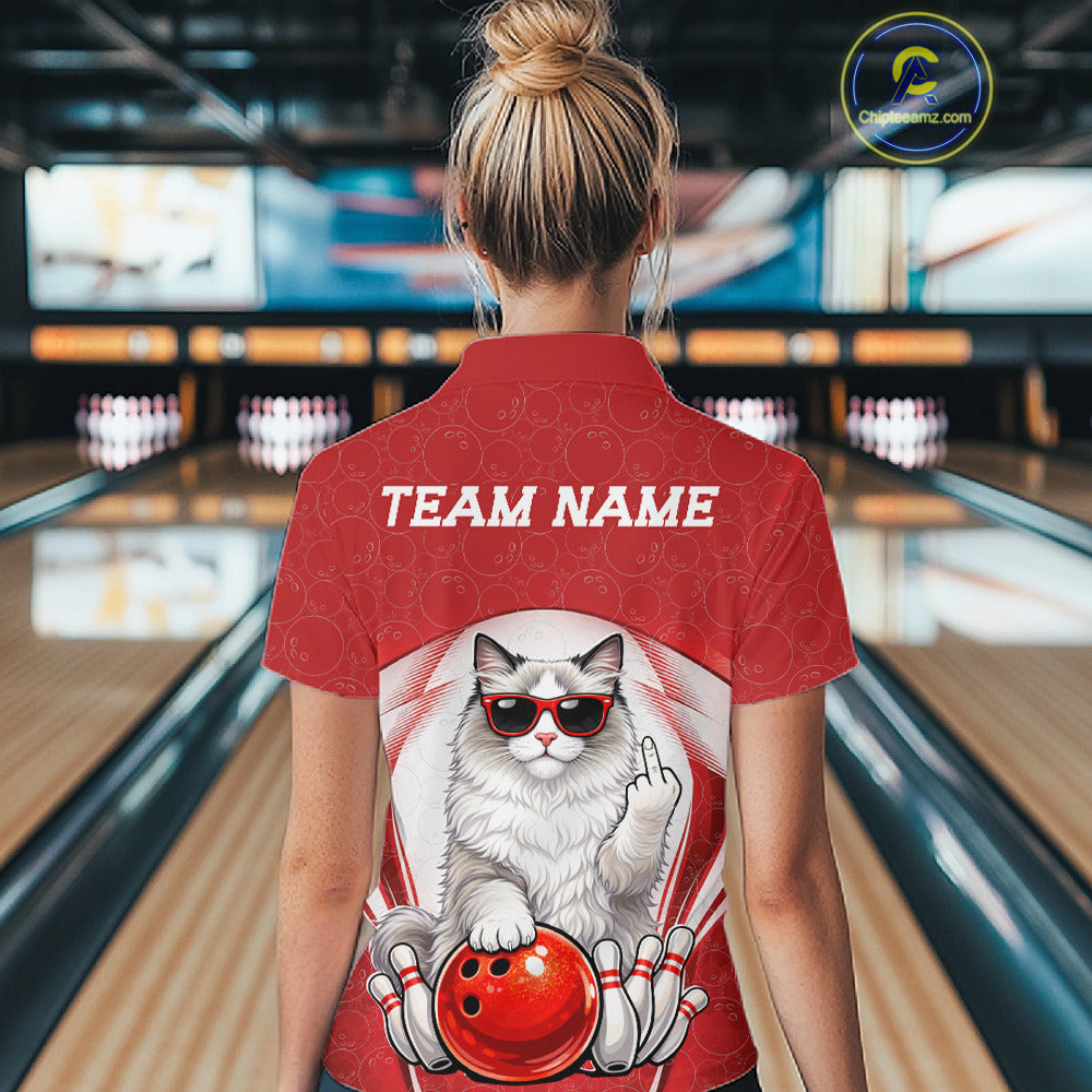 Back view of a female model in a bowling center wearing a white and red polo shirt showcasing a ragdoll cat beside a bowling ball.