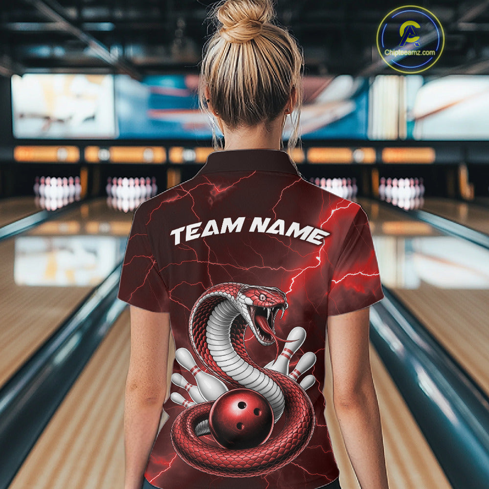 Back view of a womens bowling polo displaying a red cobra wrapped around a bowling ball with scattered pins.