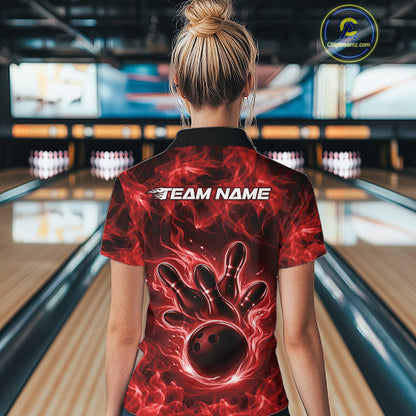 Back view of a red womens bowling polo displaying a bowling ball encircled by flames.