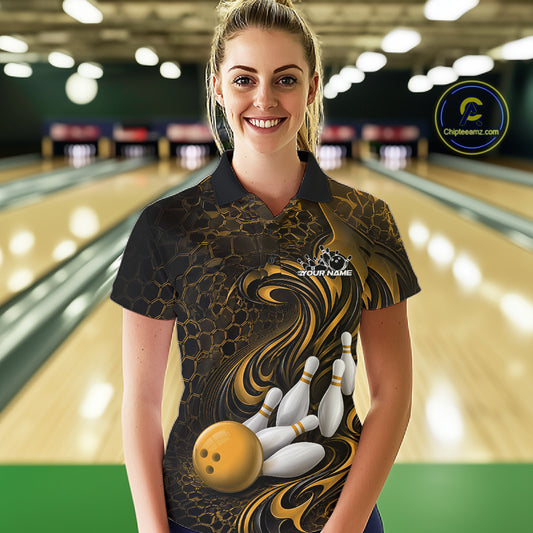 Female model wearing a black and yellow bowling polo shirt in a bowling alley featuring a tribal flame bowling ball and pins graphic