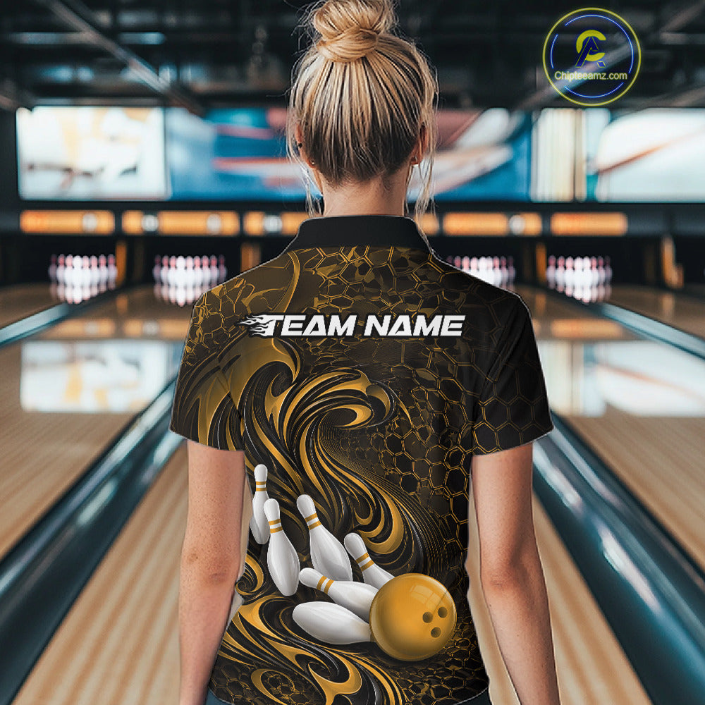 Back view of a female model wearing a black and yellow bowling polo shirt in a bowling alley featuring a tribal flame bowling ball and pins graphic
