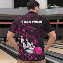 Load image into Gallery viewer, Male model standing in a bowling lane wearing a black and pink bowling quarter-zip shirt featuring a tribal flame bowling ball and pins graphic on the front.