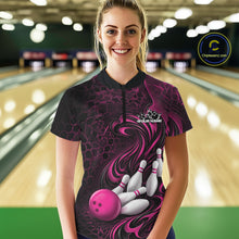 Load image into Gallery viewer, Female model standing in a bowling lane wearing a black and pink bowling quarter-zip shirt featuring a tribal flame bowling ball and pins graphic on the front.