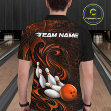 Load image into Gallery viewer, Male model standing in a bowling lane showing the back of a black and orange bowling polo shirt with a tribal flame bowling ball and pins graphic.