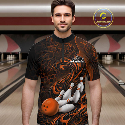 Male model standing in a bowling lane wearing a black and orange bowling quarter-zip shirt featuring a tribal flame bowling ball and pins graphic on the front.