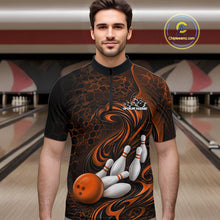 Load image into Gallery viewer, Male model standing in a bowling lane wearing a black and orange bowling quarter-zip shirt featuring a tribal flame bowling ball and pins graphic on the front.