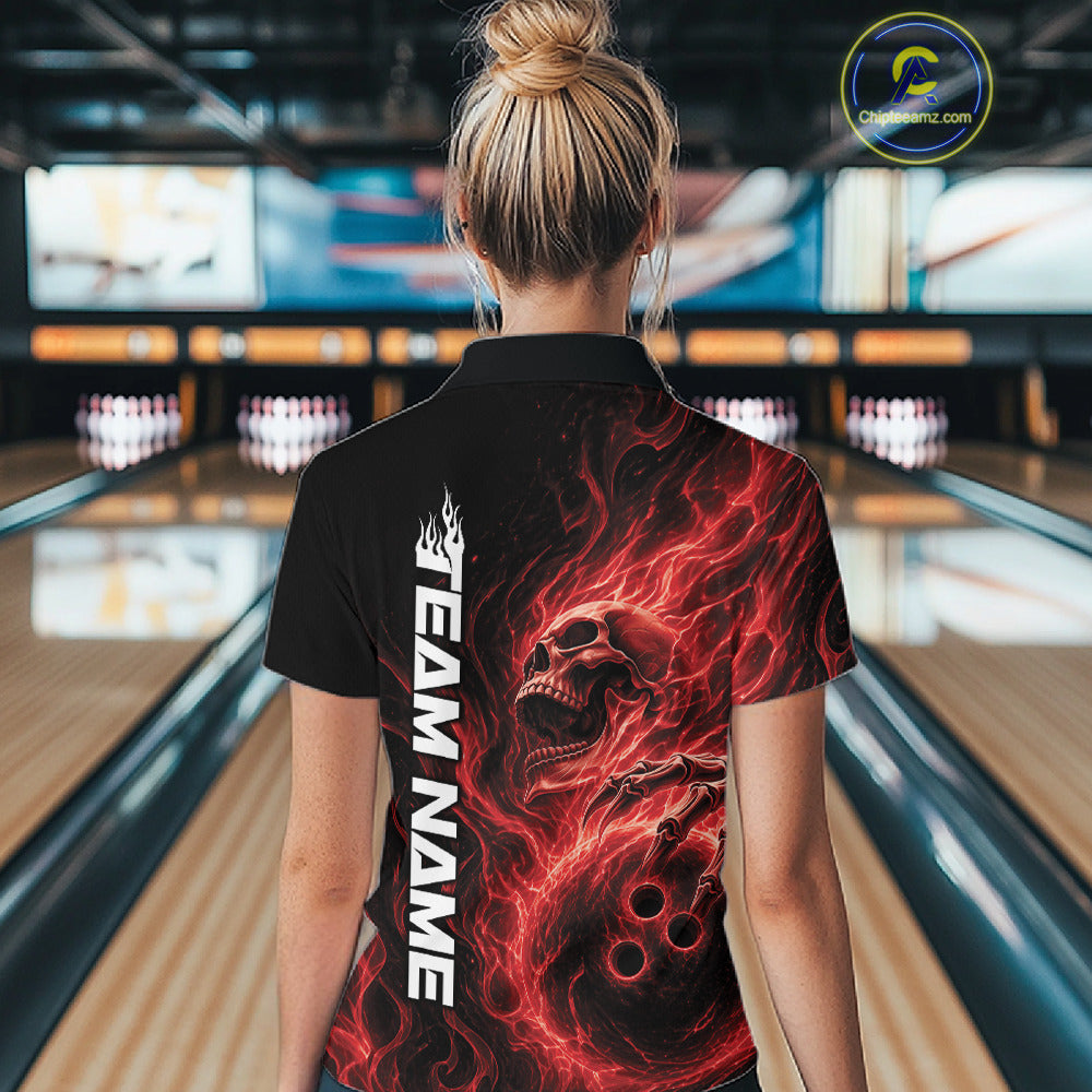 Back view of a female model wearing a black bowling polo shirt in a bowling alley featuring a skull clutching a bowling ball with swirling red energy flames