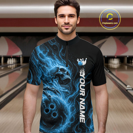 Male model wearing a black bowling quarter-zip shirt in a bowling alley featuring a skull clutching a bowling ball with swirling blue energy flames