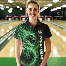 Load image into Gallery viewer, Female model wearing a black bowling polo shirt in a bowling alley featuring a skull clutching a bowling ball with swirling green energy flames