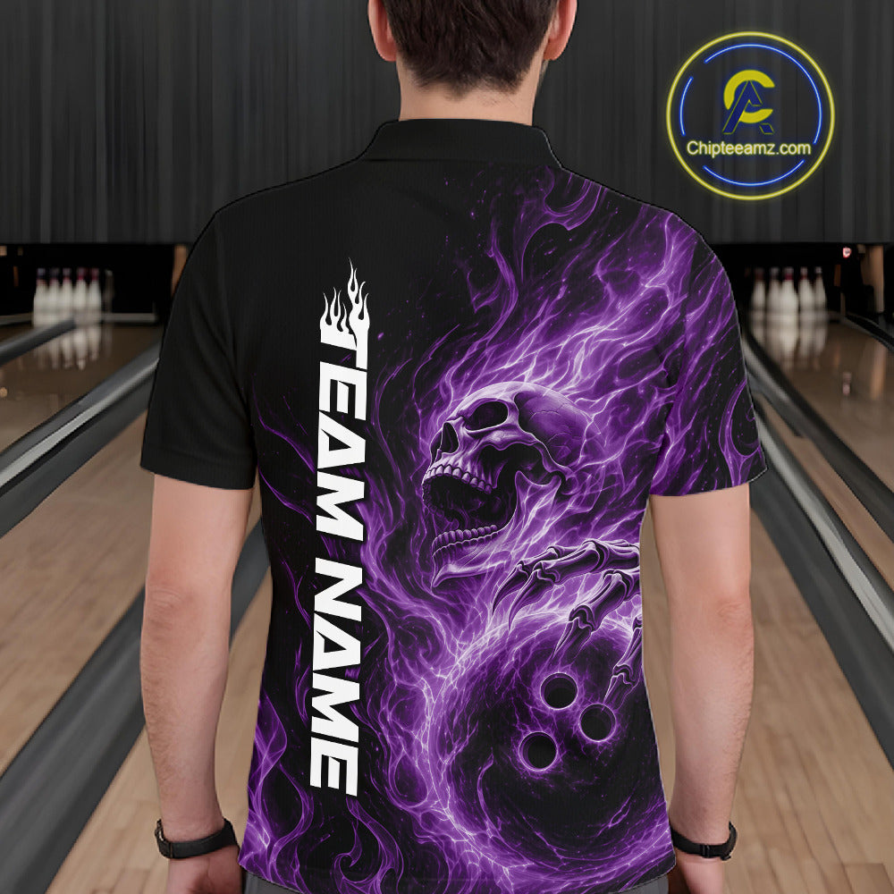 Back view of a male bowler in a bowling alley wearing a black bowling polo shirt featuring a purple energy-flame skull clutching a bowling ball
