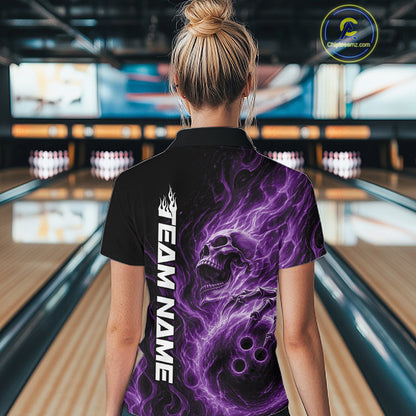 Back view of a female model wearing a black bowling polo shirt in a bowling alley featuring a skull clutching a bowling ball with swirling purple energy flames