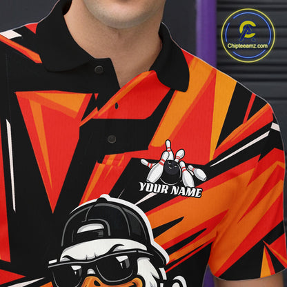 Close-up of the left chest on a black and orange bowling polo featuring a duck in sunglasses and cap beside bowling pins and a bowling ball.