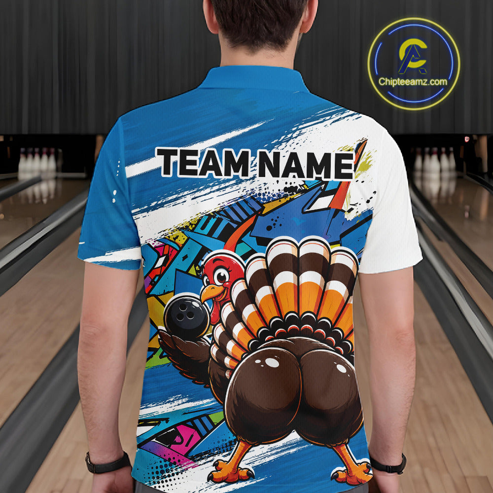 Back view of a male model wearing a blue custom bowling polo shirt featuring a funny graffiti style turkey holding a bowling ball, paint splatter details, and a custom name in a bowling alley.