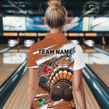 Load image into Gallery viewer, Back view of a female model wearing an orange custom bowling polo shirt with a funny graffiti turkey holding a bowling ball, paint splatter accents, and a personalized name in a bowling alley.