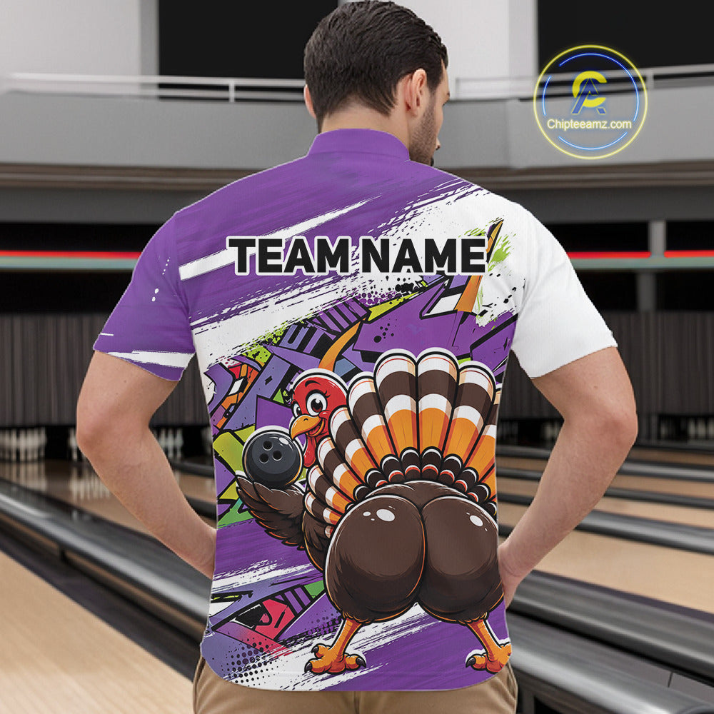 Back view of a male model in a bowling alley wearing a purple custom quarter zip bowling shirt with a funny graffiti turkey holding a bowling ball, paint splatter accents, and a personalized name.