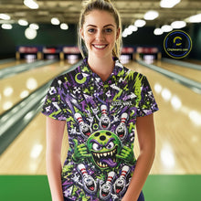 Load image into Gallery viewer, Front view of a female model at a bowling lane wearing a green and purple bowling polo shirt featuring a mischievous green monster bowling ball with sharp teeth, a purple tongue, playful hand gesture, and cheerful cartoon bowling pins.