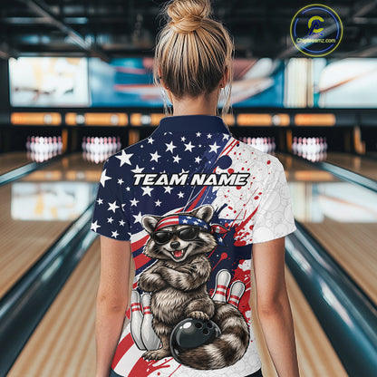 Back view female model in bowling lane wearing quarter zip shirt featuring raccoon with sunglasses and patriotic bandana leaning on a bowling ball with playful bowling graphics.