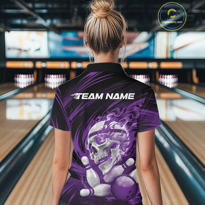 Person wearing a purple bowling shirt with a skull design in a bowling alley.