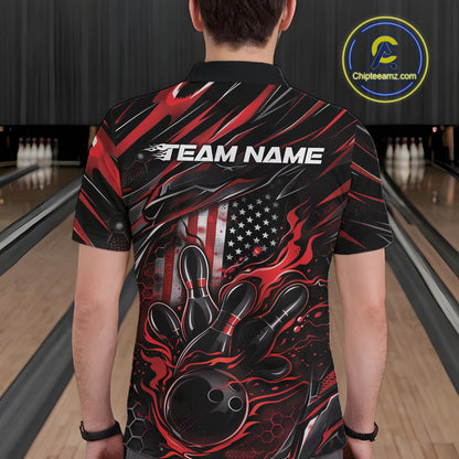 Back view of a male model in a bowling alley wearing a black and red polo shirt featuring a flaming bowling strike scene with patriotic styling.