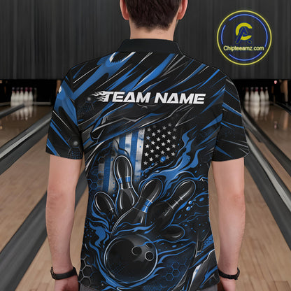 Back view of a male model in a bowling center wearing a black and blue polo shirt featuring a flaming bowling ball knocking down pins.