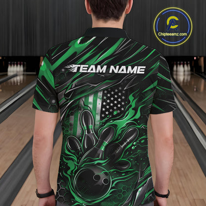 Back view of a male model in a bowling center wearing a black and green polo shirt featuring a flaming bowling ball and patriotic pin design.