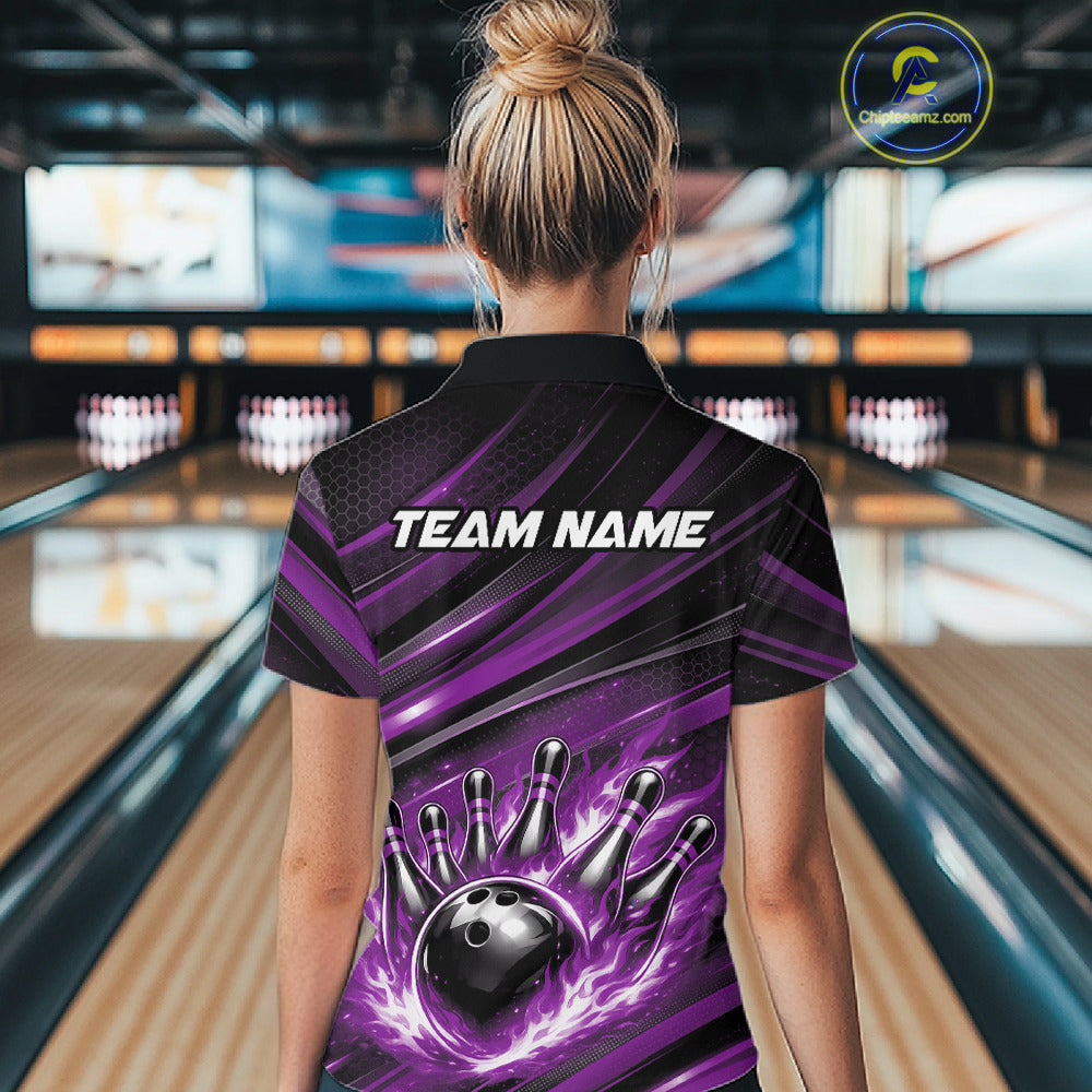 Female model at a bowling lane, back view of black and purple quarter zip shirt showcasing fiery bowling ball hitting pins with dynamic abstract stripes
