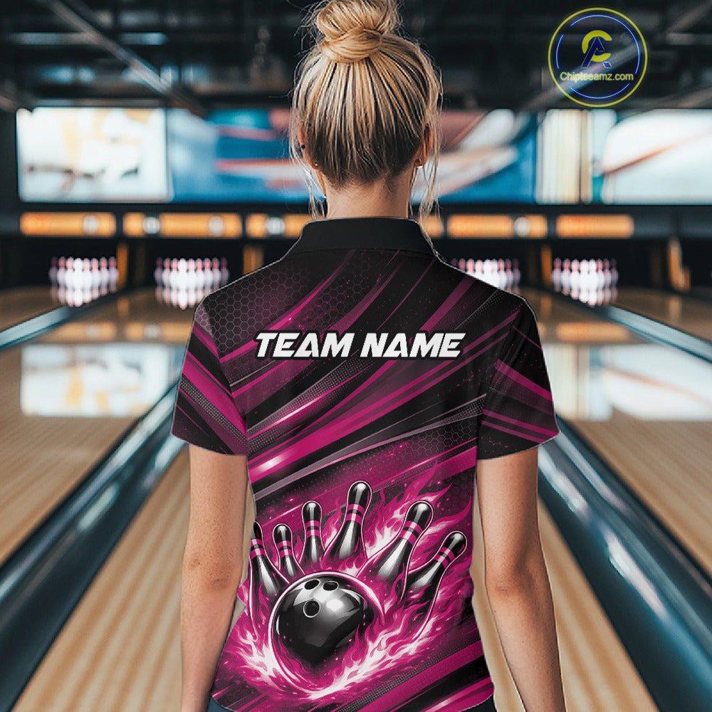 Back view of a female model in a bowling center wearing a black and pink polo shirt featuring a flaming bowling ball and pin design.