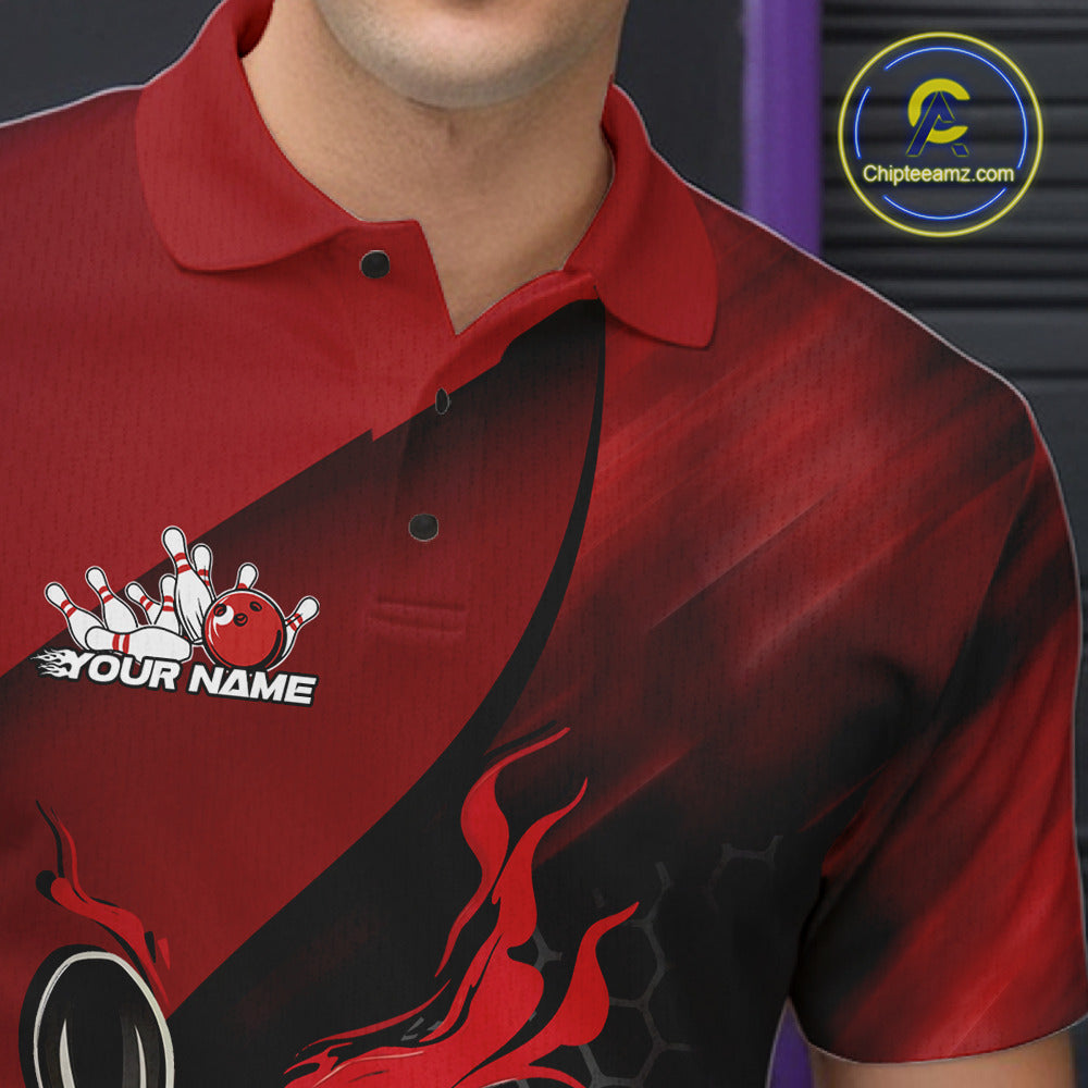 Back view of a male model in a bowling alley wearing a black and red polo shirt featuring a flaming bowling ball and pin motif.