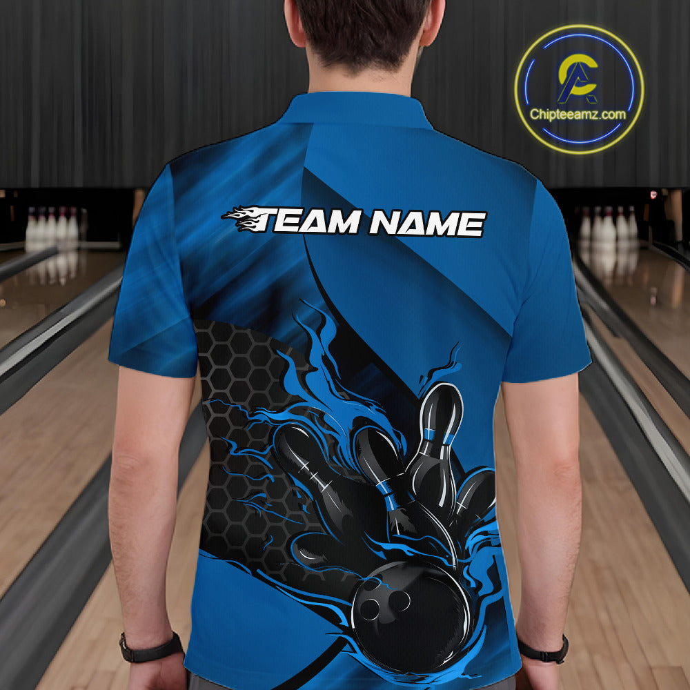 Back view of a male model in a bowling alley wearing a black and blue polo shirt showcasing a flaming bowling ball knocking down pins.