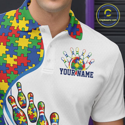 Close-up left chest detail of white bowling polo shirt featuring colorful autism bowling strike emblem and puzzle-inspired design