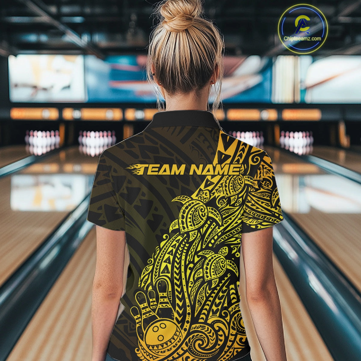 Back view of a female model in a black and gold bowling polo shirt showcasing tribal swirl bowling artwork.