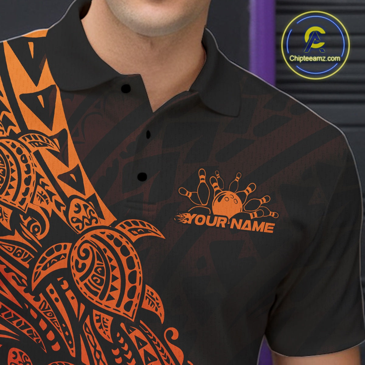 Close-up of the left chest on a black and red orange bowling polo shirt featuring tribal bowling artwork with Polynesian details.
