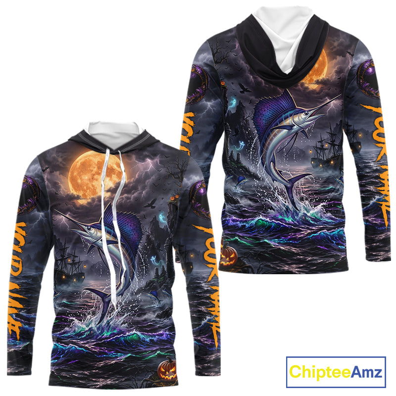 A long-sleeve hooded sweatshirt shown from the front and back, featuring an all-over Halloween-themed graphic print with a jumping marlin, stormy ocean, full moon, pirate ship, and orange text on the sleeves. The hoodie has a black hood with white drawstrings and a white inner collar.