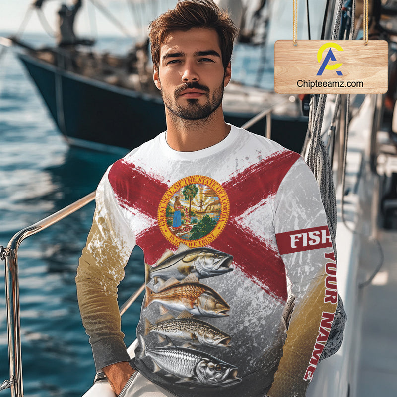 Man wearing a fishing-themed shirt with a boat in the background