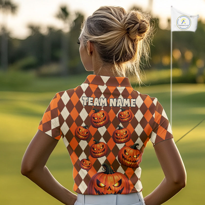 A woman seen from behind wearing a short-sleeve collared polo shirt with an orange and cream harlequin pattern, pumpkin graphics, and 'TEAM NAME' printed across the back, standing on a golf course.
