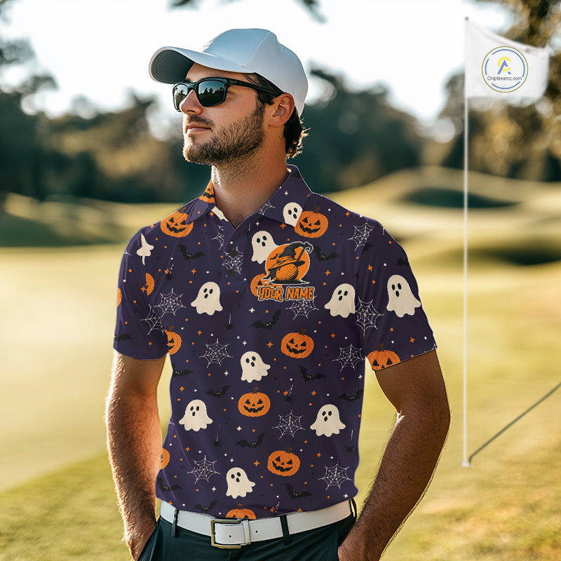 A man wearing a dark purple short-sleeve polo shirt with a Halloween pattern of orange pumpkins, white ghosts, and spiderwebs, standing on a golf course.