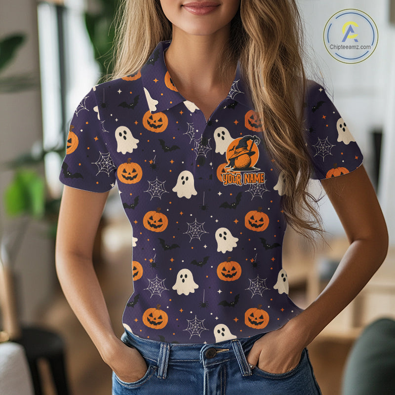 A woman wearing a short-sleeve polo shirt with a Halloween pattern of orange pumpkins, white ghosts, and black bats on a dark purple background. The shirt features a custom name patch that reads 'YOUR NAME'.