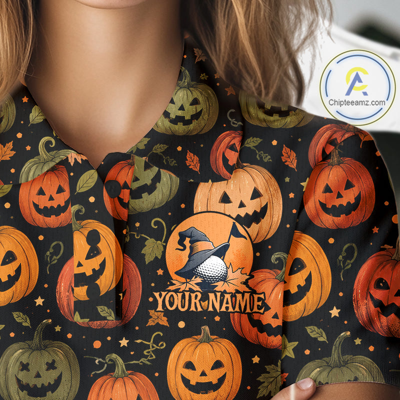 A close-up of a person wearing a black short-sleeve collared shirt with a Halloween print of orange and green jack-o'-lanterns, stars, and leaves. The shirt features a customizable circular design with a witch's hat, golf ball, and the text 'YOUR_NAME'.