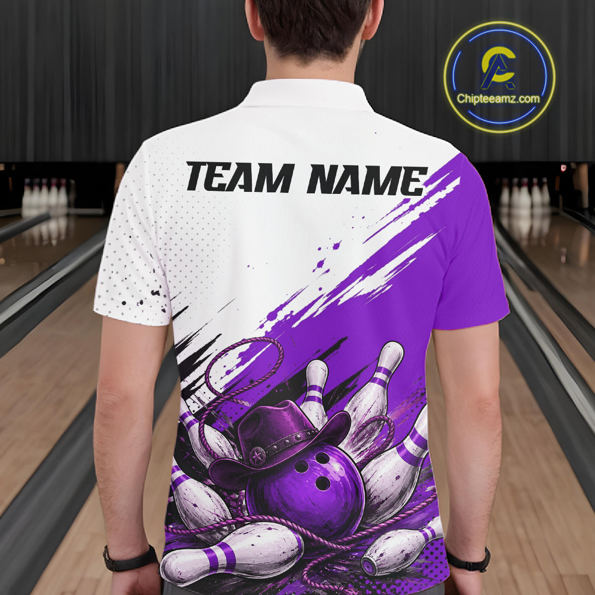 A man viewed from behind wearing a custom short-sleeve bowling t-shirt with a white and purple design featuring bowling pins, balls, and a cowboy hat. The shirt has 'TEAM NAME' printed on the back.